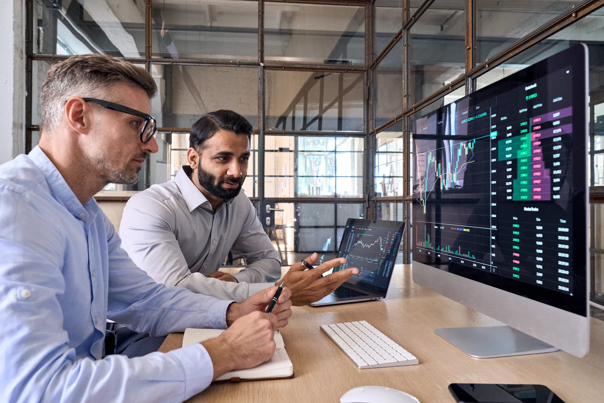 Medical professionals reviewing data on screens